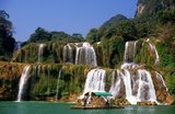 Ban Gioc – Detian Falls (Chinese: 德天瀑布 &板約瀑布 - Vietnamese: Thác Bản Giốc & Thác Đức Thiên) are 2 waterfalls on the Quây Sơn River or Guichun River straddling the Sino-Vietnamese border, located in the Karst hills of Daxin County in the Chongzuo prefecture-level city of Guangxi Province, on the Chinese side, and in the district of Trung Khanh District, Cao Bằng province on the Vietnamese side, 272 km north of Hanoi.<br/><br/>

Guangxi, formerly romanized Kwangsi, is a province of southern China along its border with Vietnam. In 1958, it became the Guangxi Zhuang Autonomous Region of the People's Republic of China, a region with special privileges created specifically for the Zhuang people.