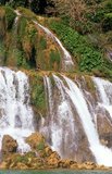 Ban Gioc – Detian Falls (Chinese: 德天瀑布 &板約瀑布 - Vietnamese: Thác Bản Giốc & Thác Đức Thiên) are 2 waterfalls on the Quây Sơn River or Guichun River straddling the Sino-Vietnamese border, located in the Karst hills of Daxin County in the Chongzuo prefecture-level city of Guangxi Province, on the Chinese side, and in the district of Trung Khanh District, Cao Bằng province on the Vietnamese side, 272 km north of Hanoi.<br/><br/>

Guangxi, formerly romanized Kwangsi, is a province of southern China along its border with Vietnam. In 1958, it became the Guangxi Zhuang Autonomous Region of the People's Republic of China, a region with special privileges created specifically for the Zhuang people.